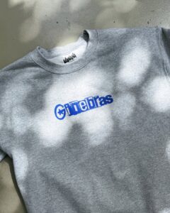 Gray crewneck sweatshirt with a blue 'Ginebras' logo across the chest.